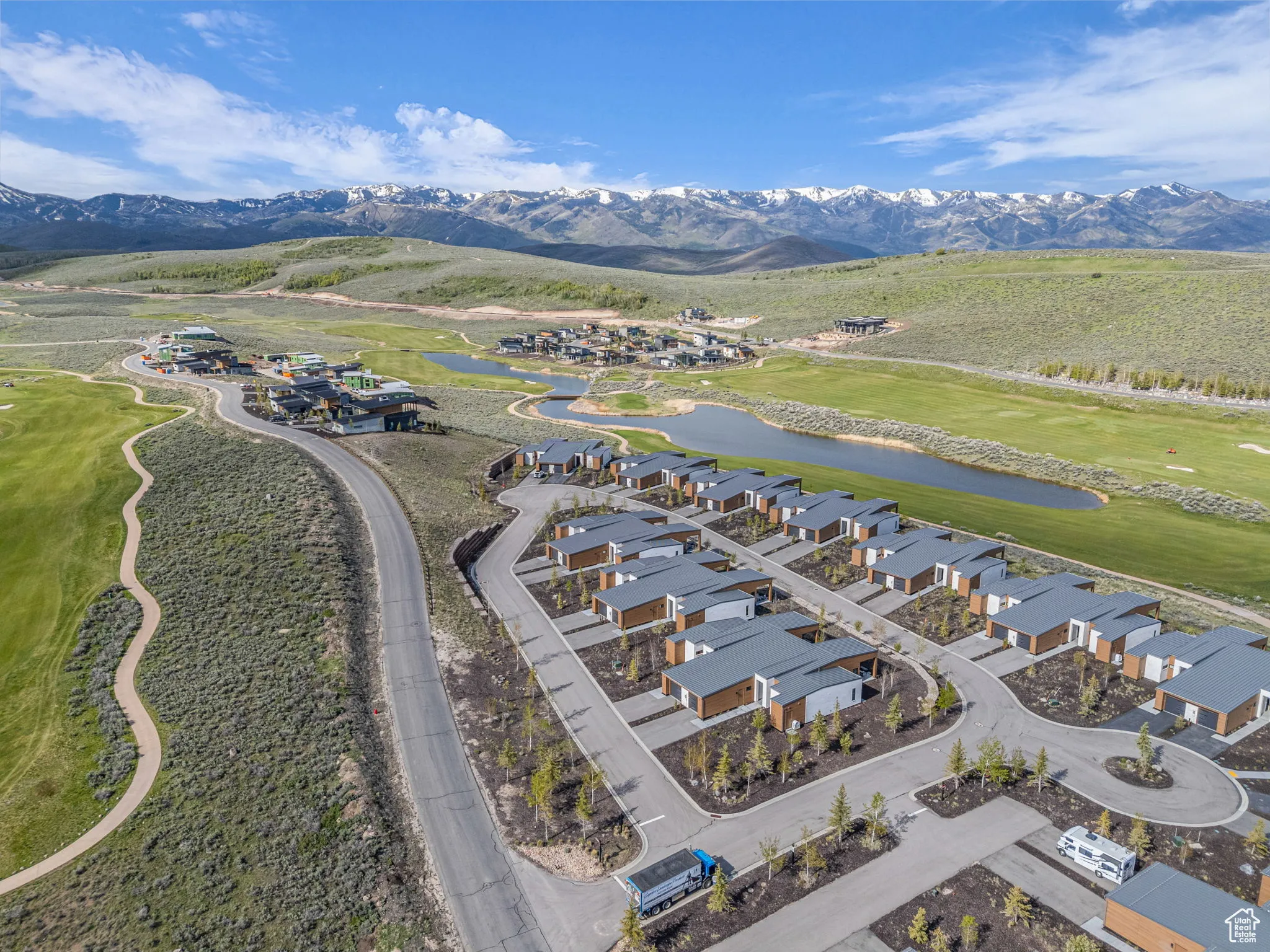 Aerial perspective of suburban area featuring a water and mountain view and a golf club