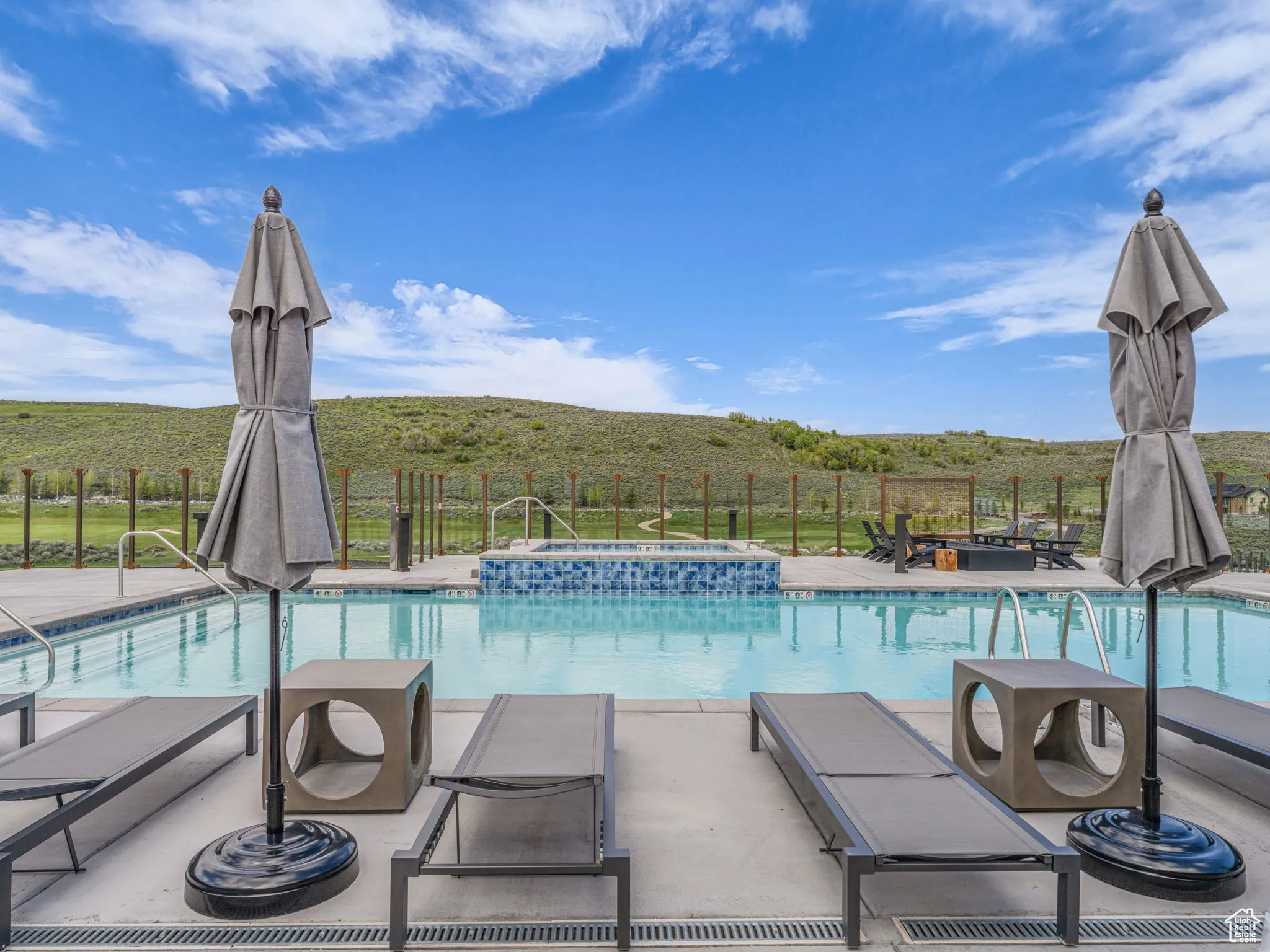 View of swimming pool with a pool with connected hot tub