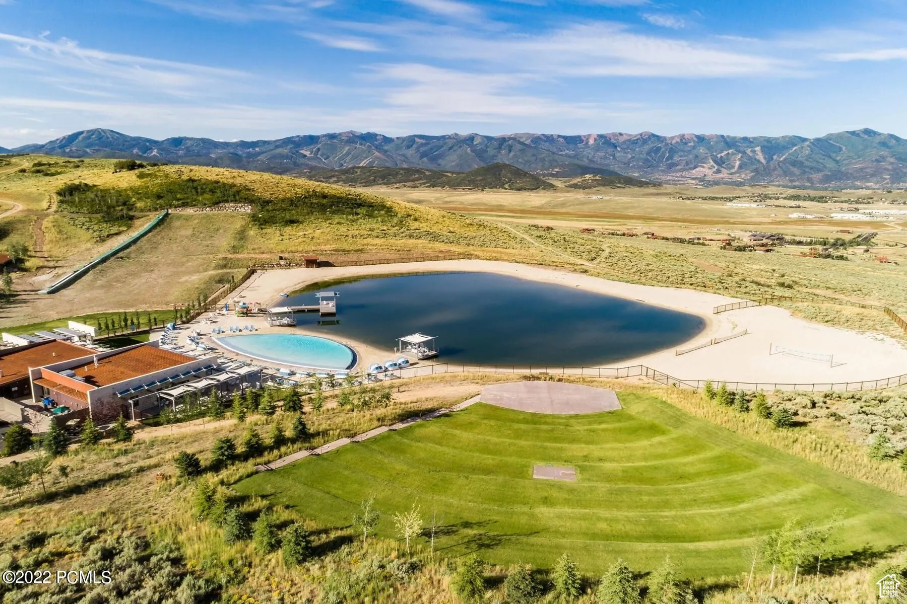 Drone / aerial view of a water and mountain view and a pool area