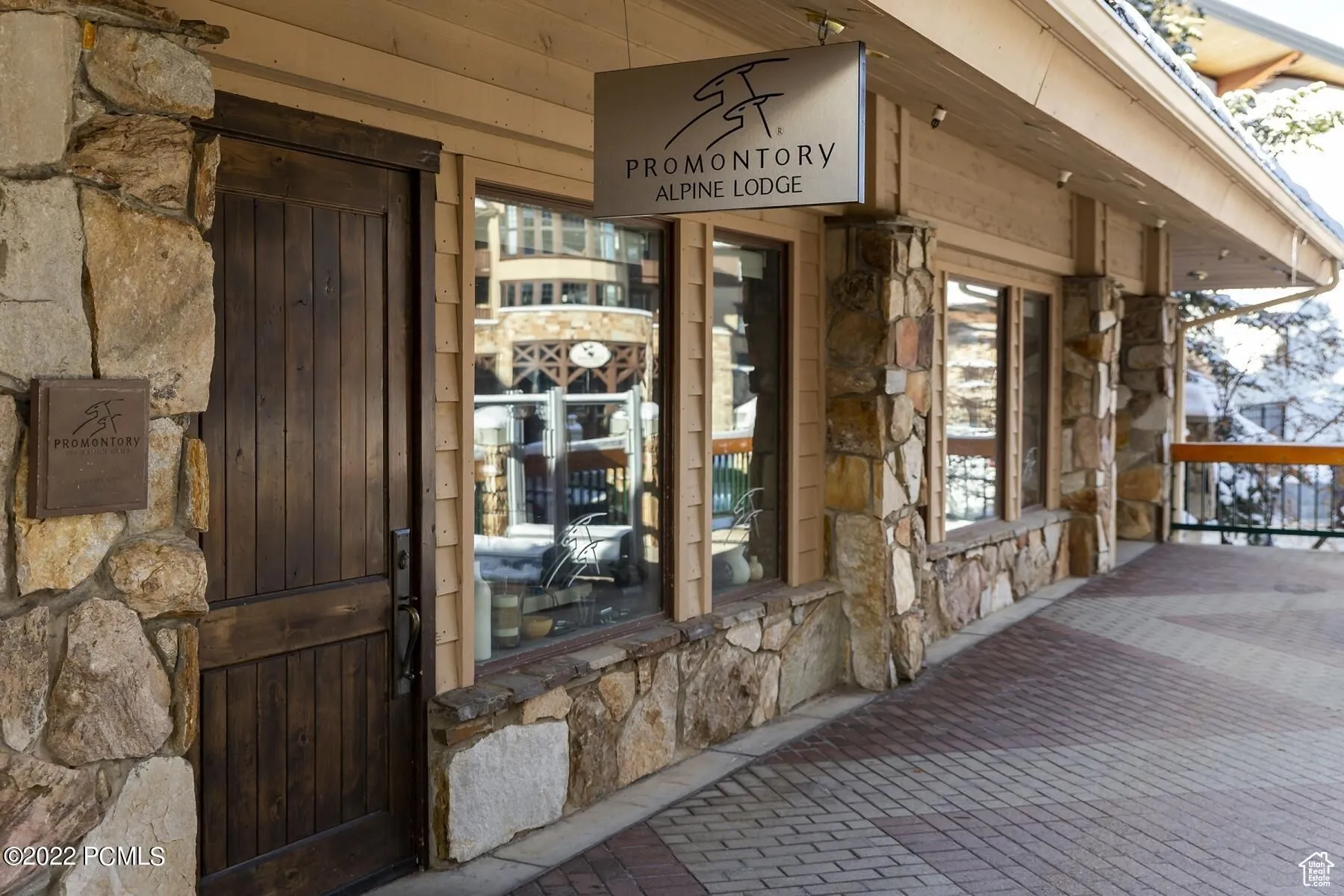 Entrance to property with stone siding and covered porch