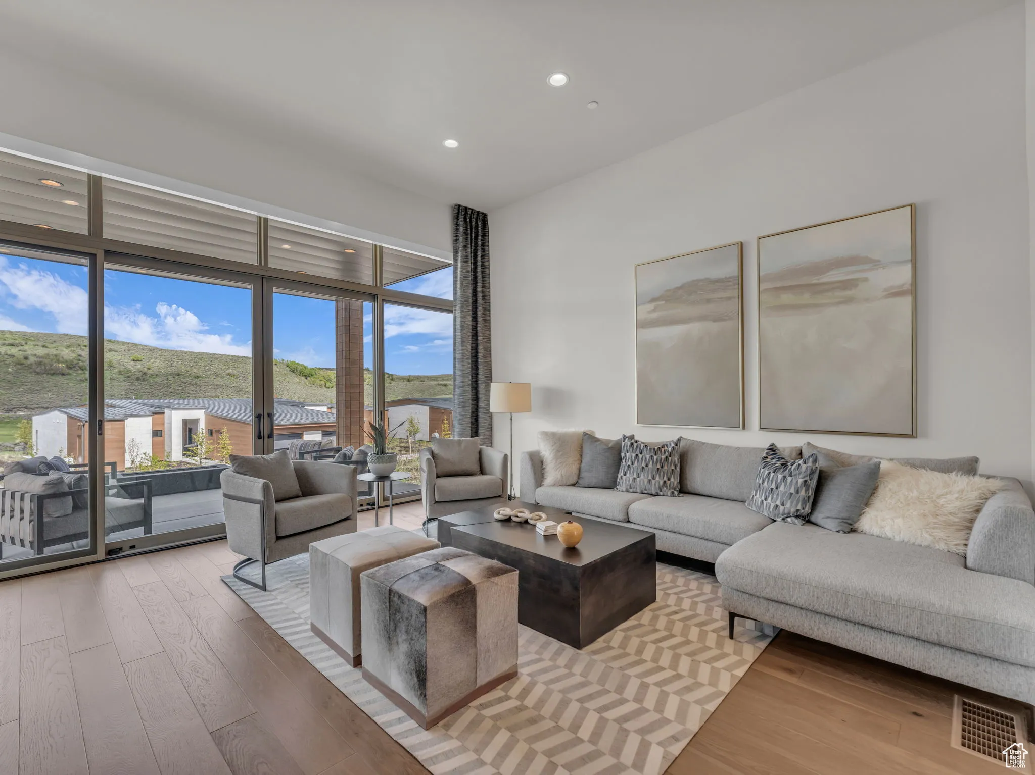 Living room with light wood-type flooring and recessed lighting