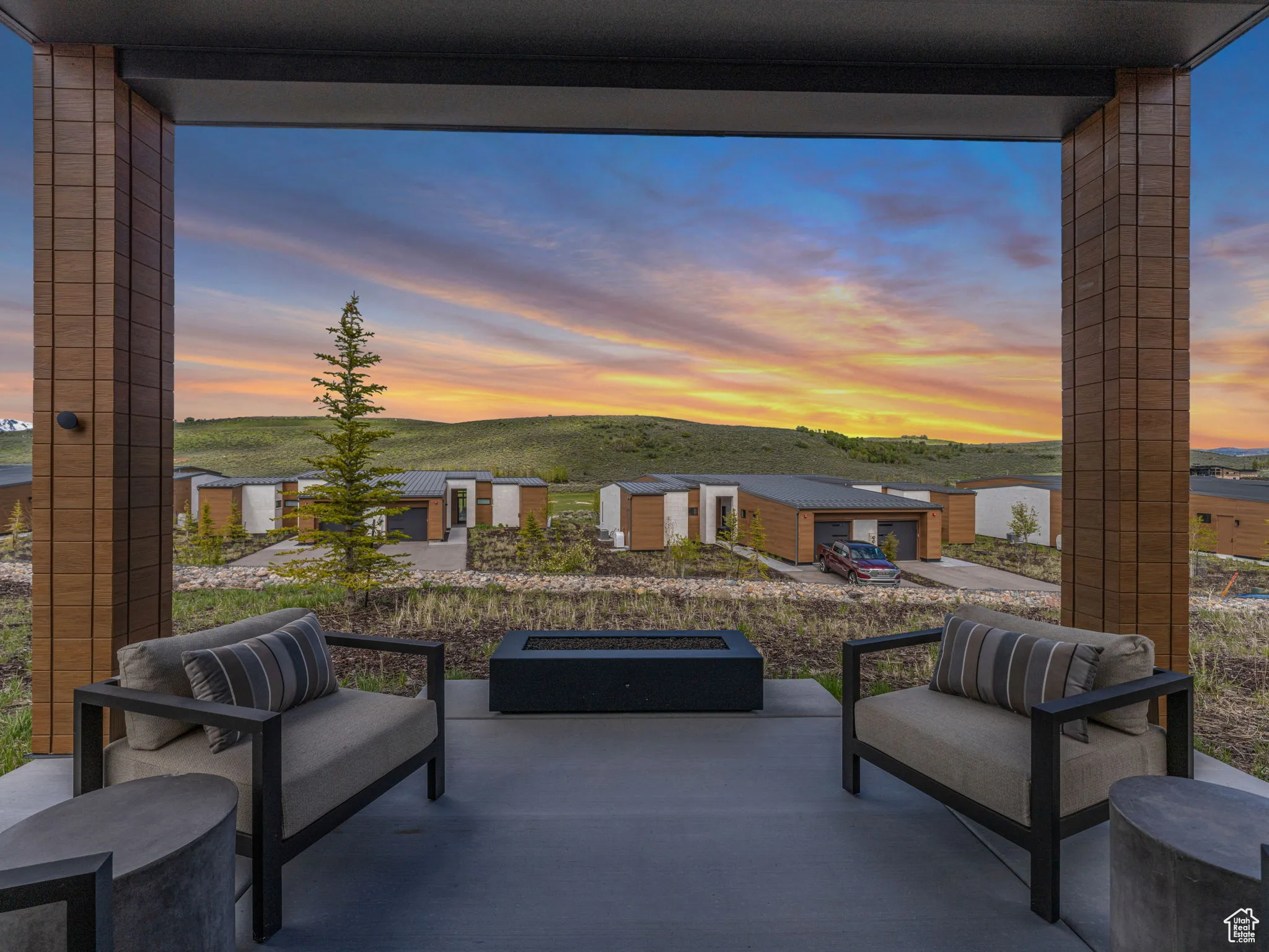 Enjoy beautiful sunsets on the covered patio with a cozy and inviting firepit