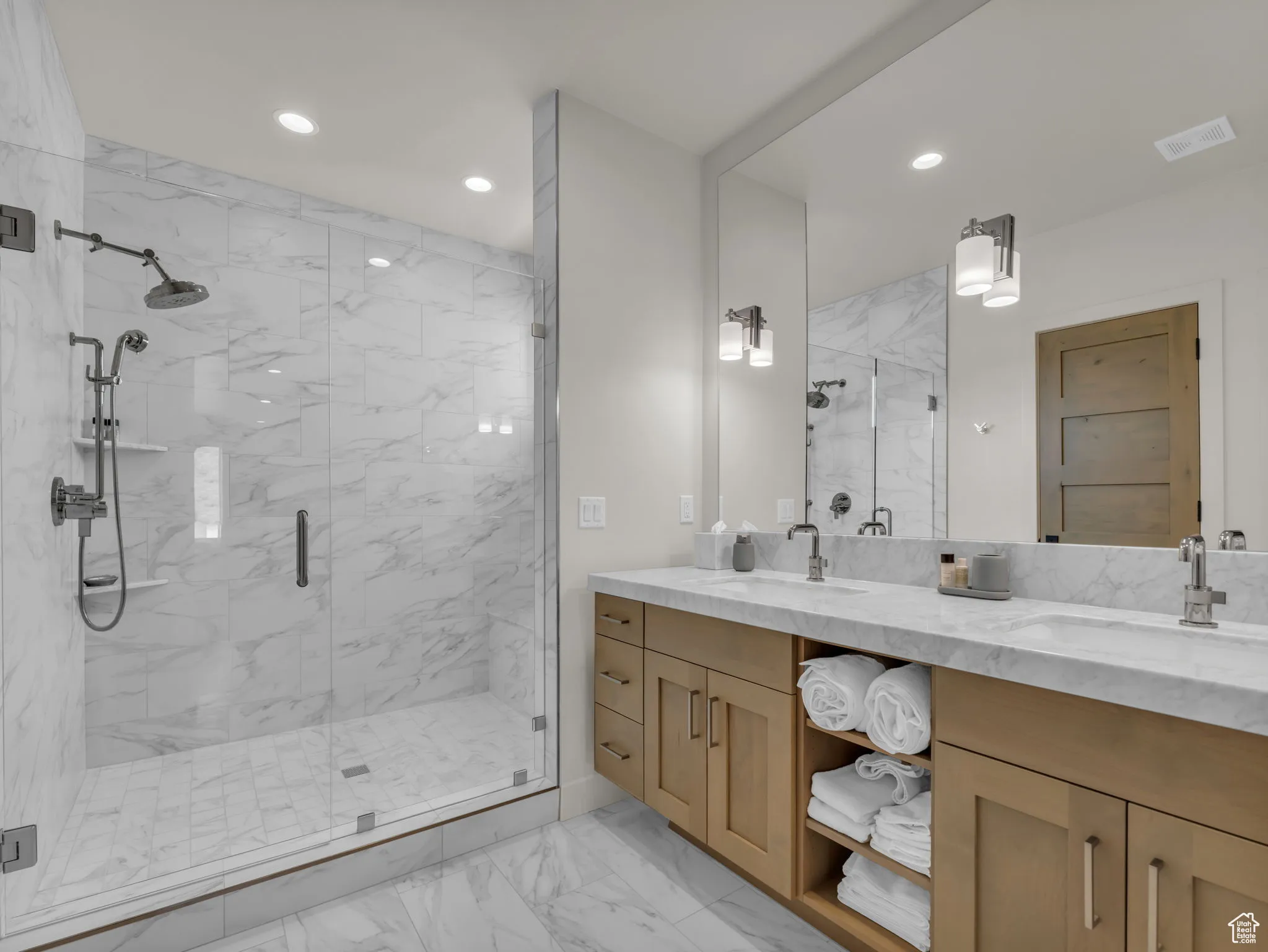 Full bathroom featuring marble look tiles, a marble finish shower, double vanity, and recessed lighting