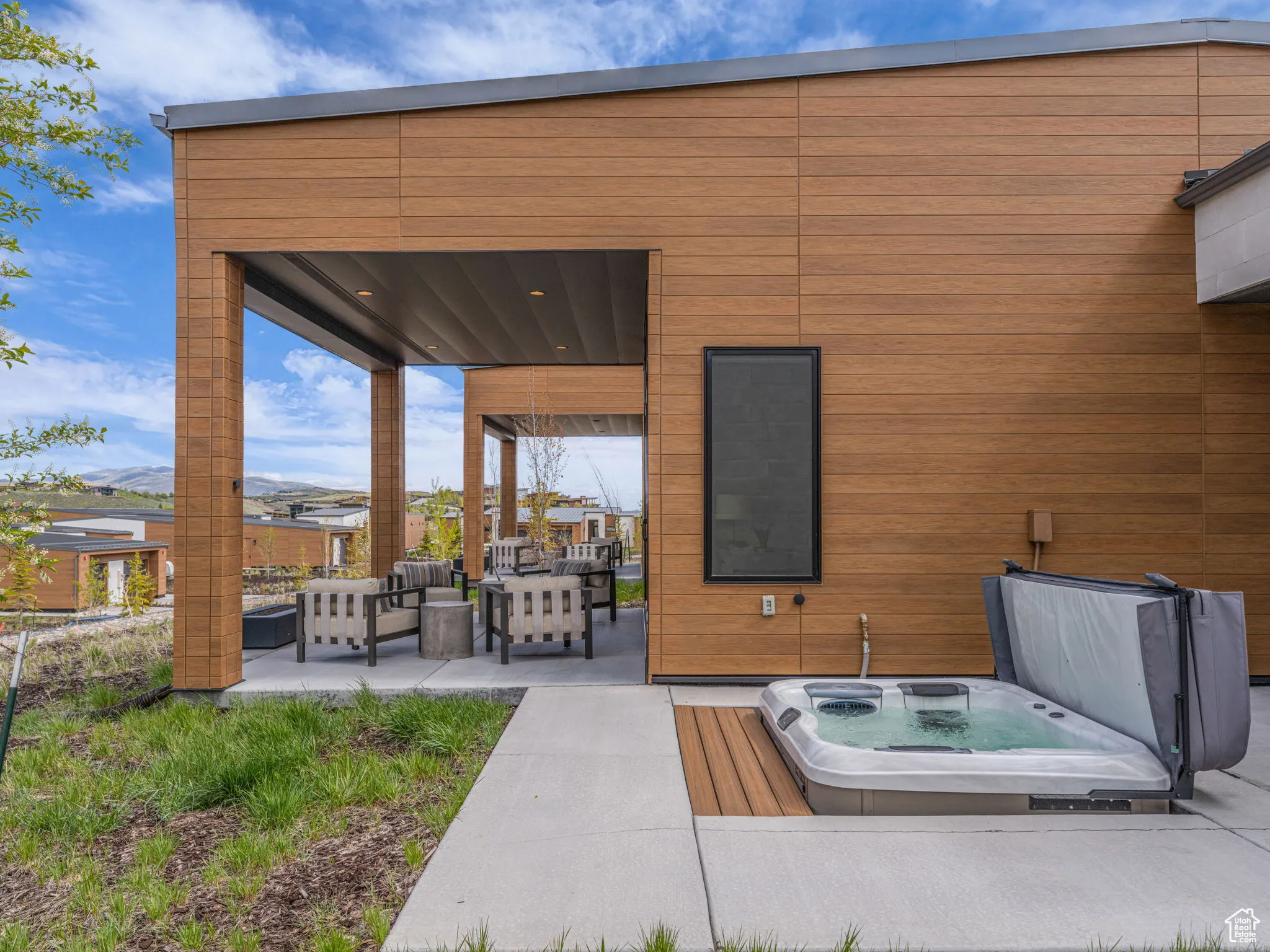 View of patio / terrace featuring a covered hot tub and an outdoor hangout area
