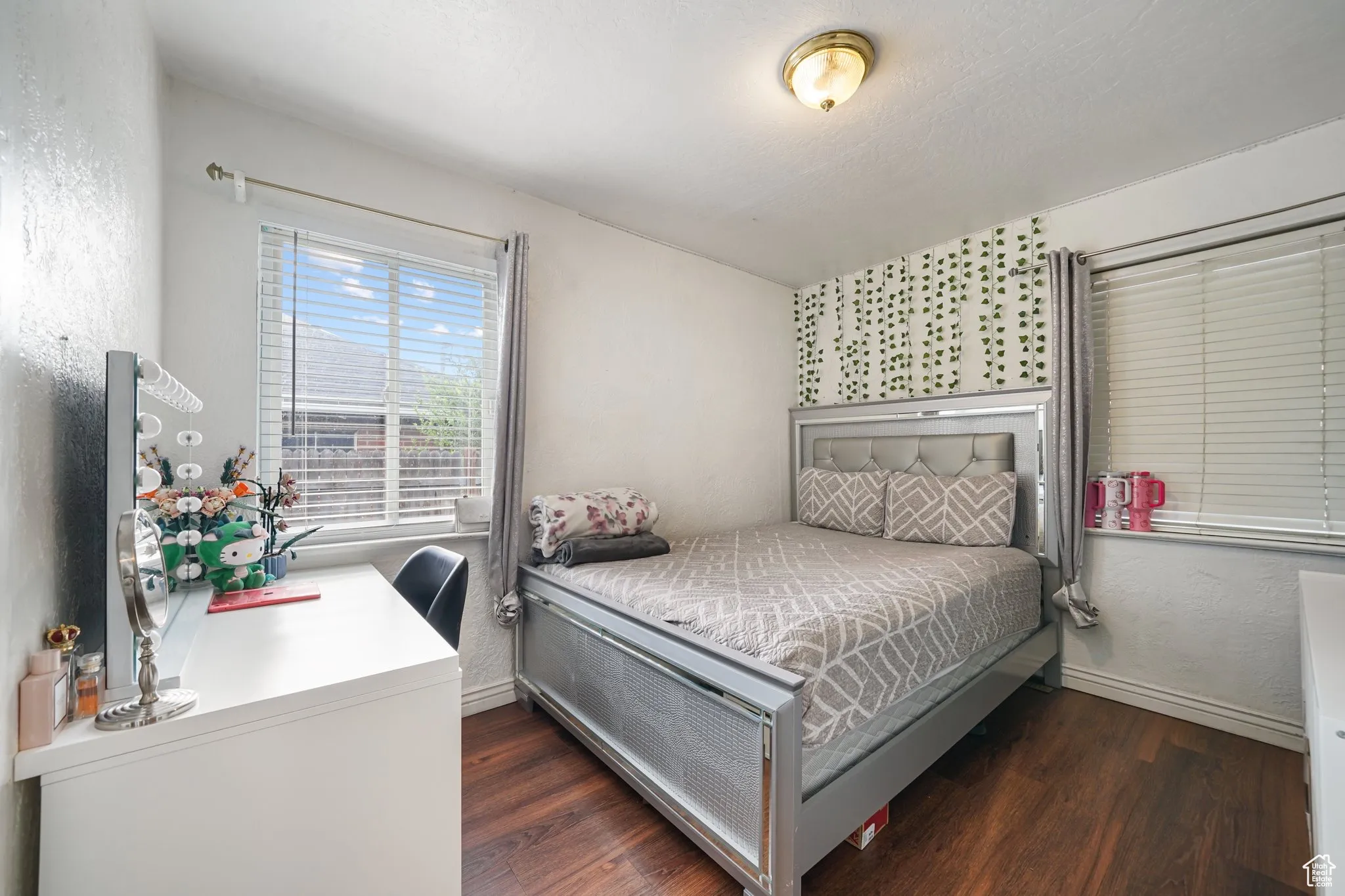 Bedroom with wood finished floors and baseboards