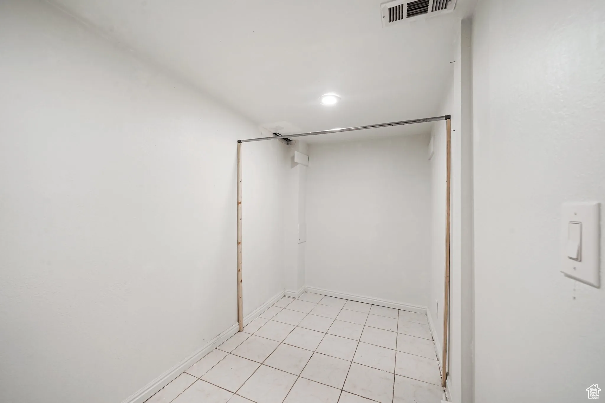 Walk in closet with light tile patterned flooring