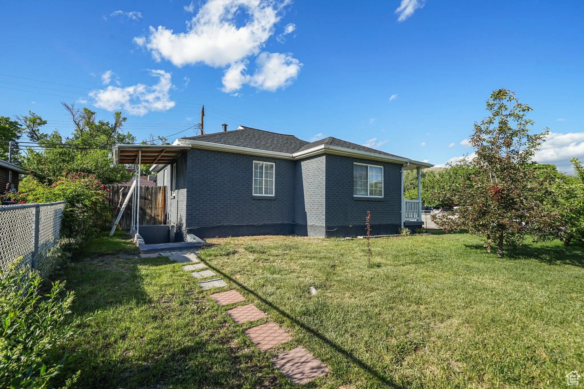 Rear view of property with brick siding