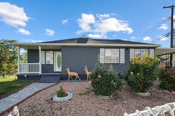 View of front of property with a porch and brick siding