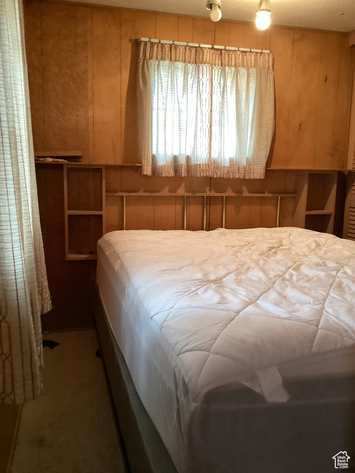 Bedroom with wood walls