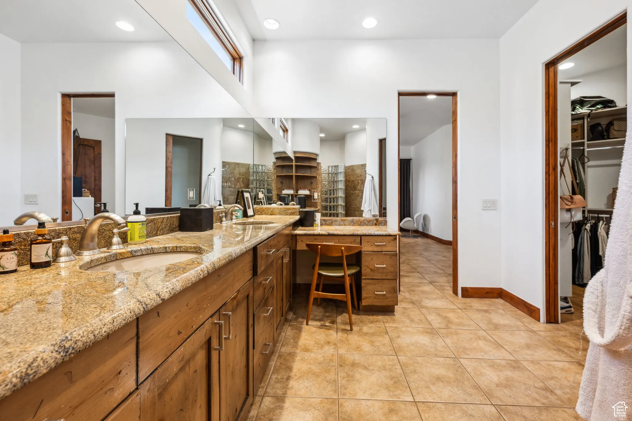 Bathroom with double vanity, tile patterned floors, a walk in closet, tasteful backsplash, and recessed lighting