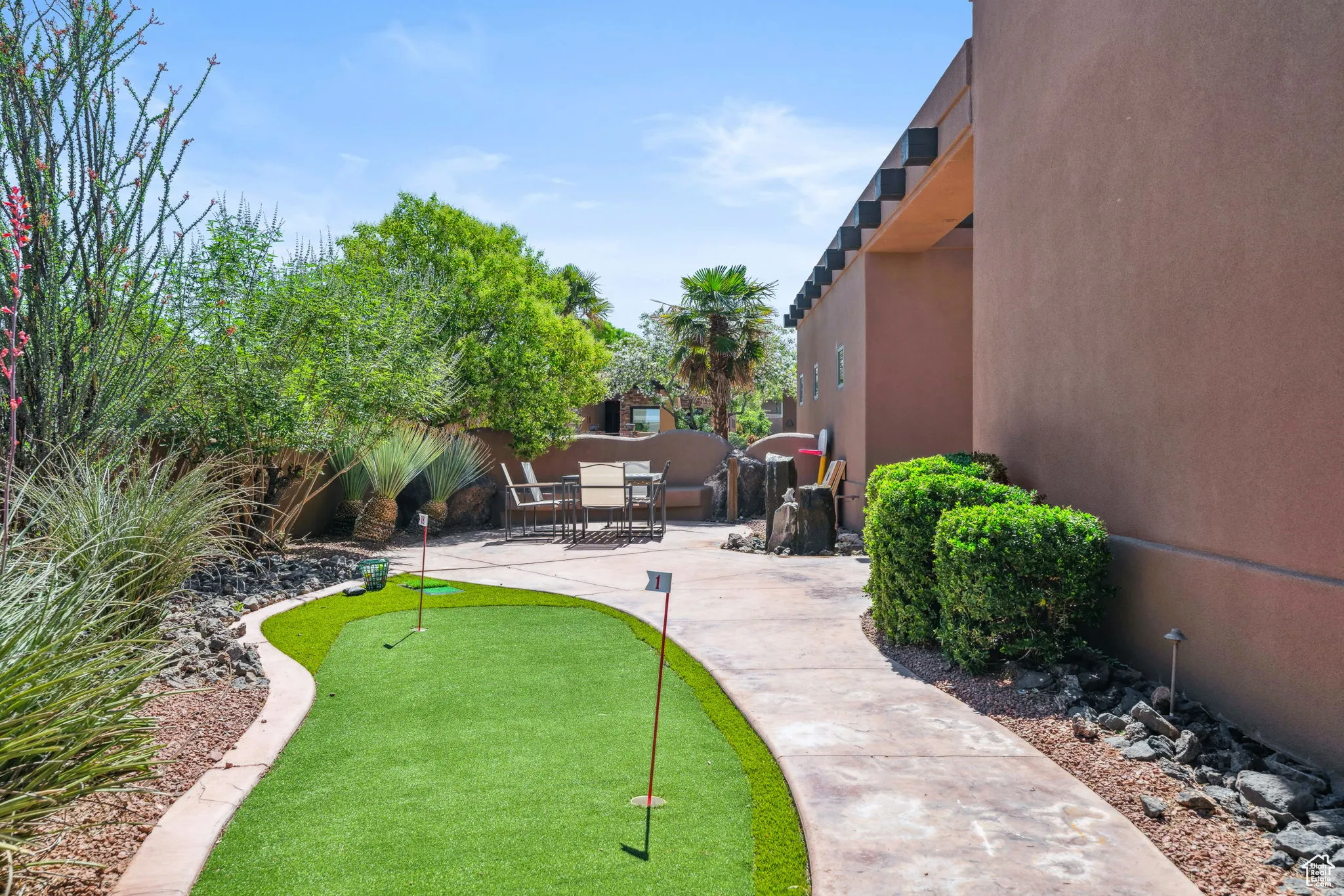 View of community featuring a putting area and a patio
