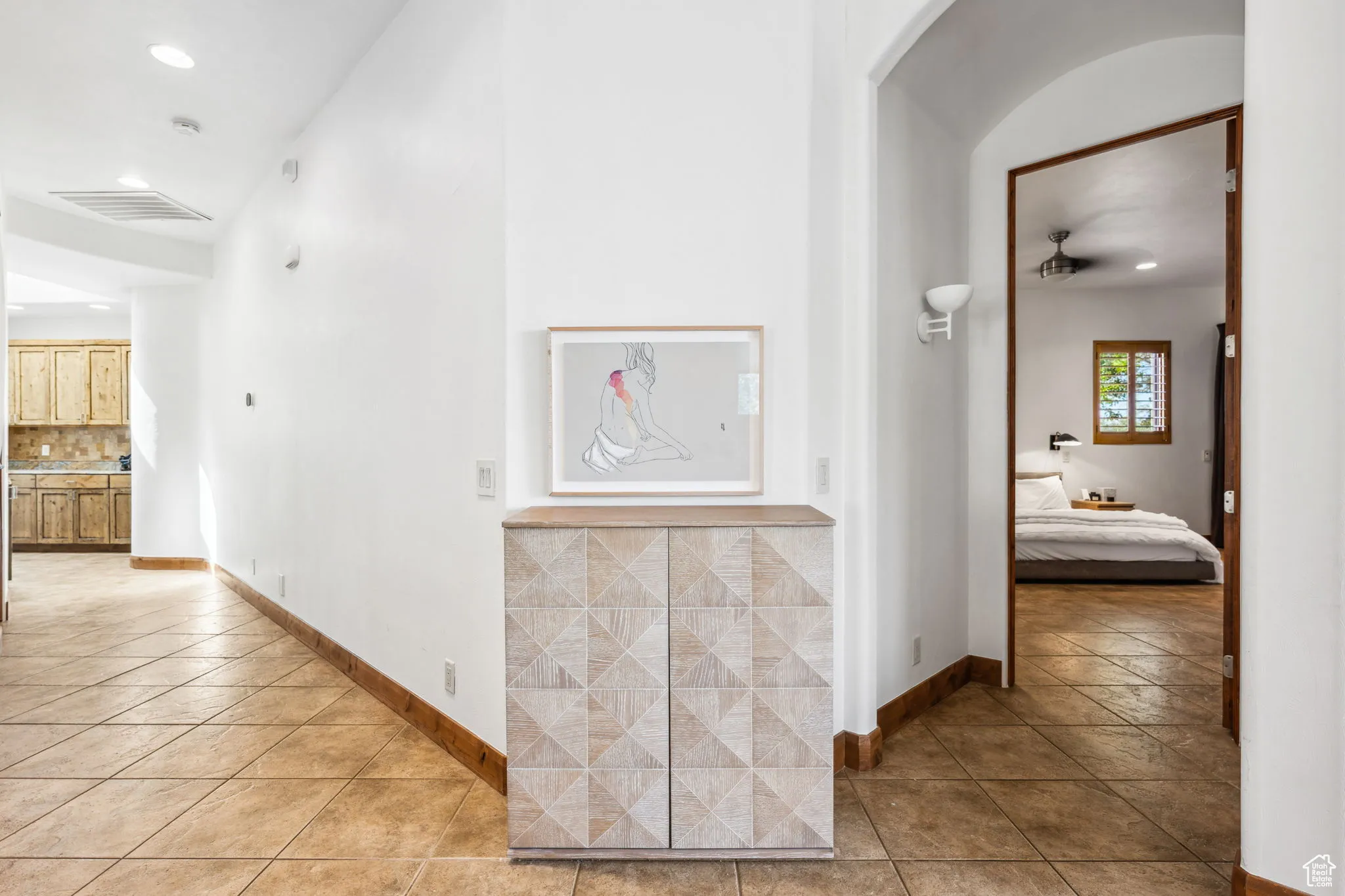 Hall with light tile patterned floors, recessed lighting, and baseboards