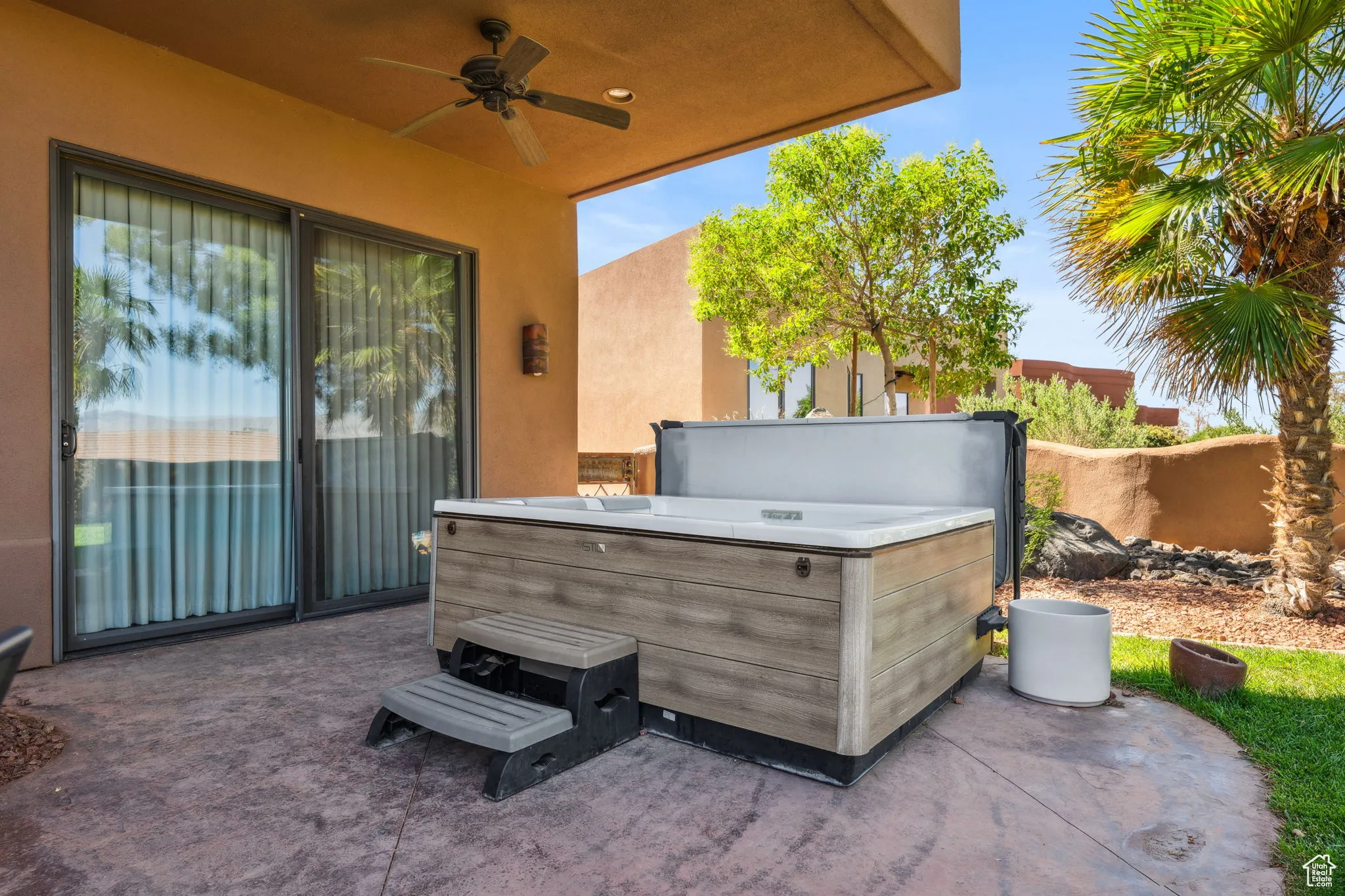 View of patio / terrace featuring a hot tub and ceiling fan