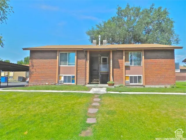 View of front facade featuring brick siding and a front yard