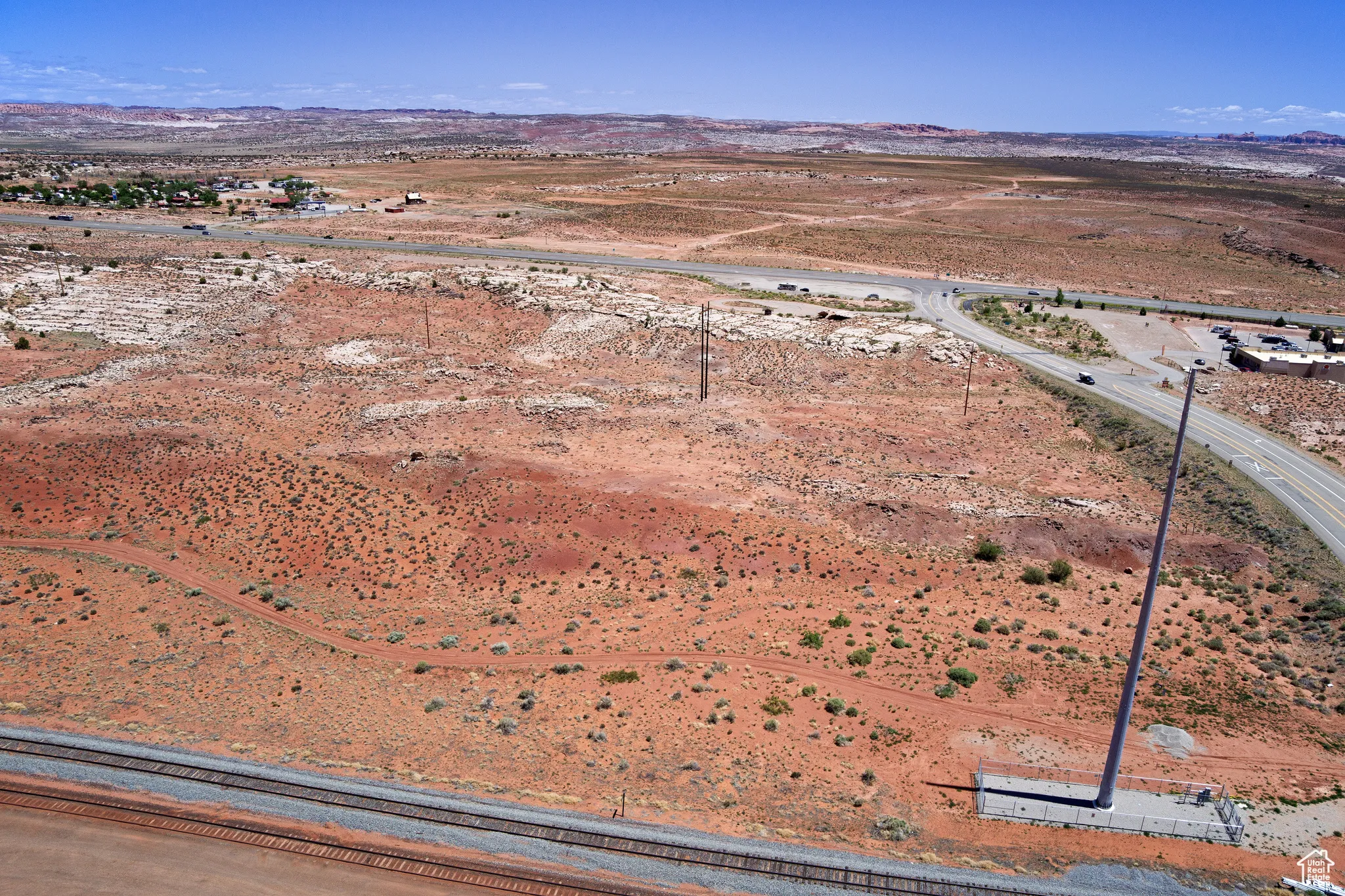 Aerial view of sparsely populated area featuring a mountainous background and a desert landscape