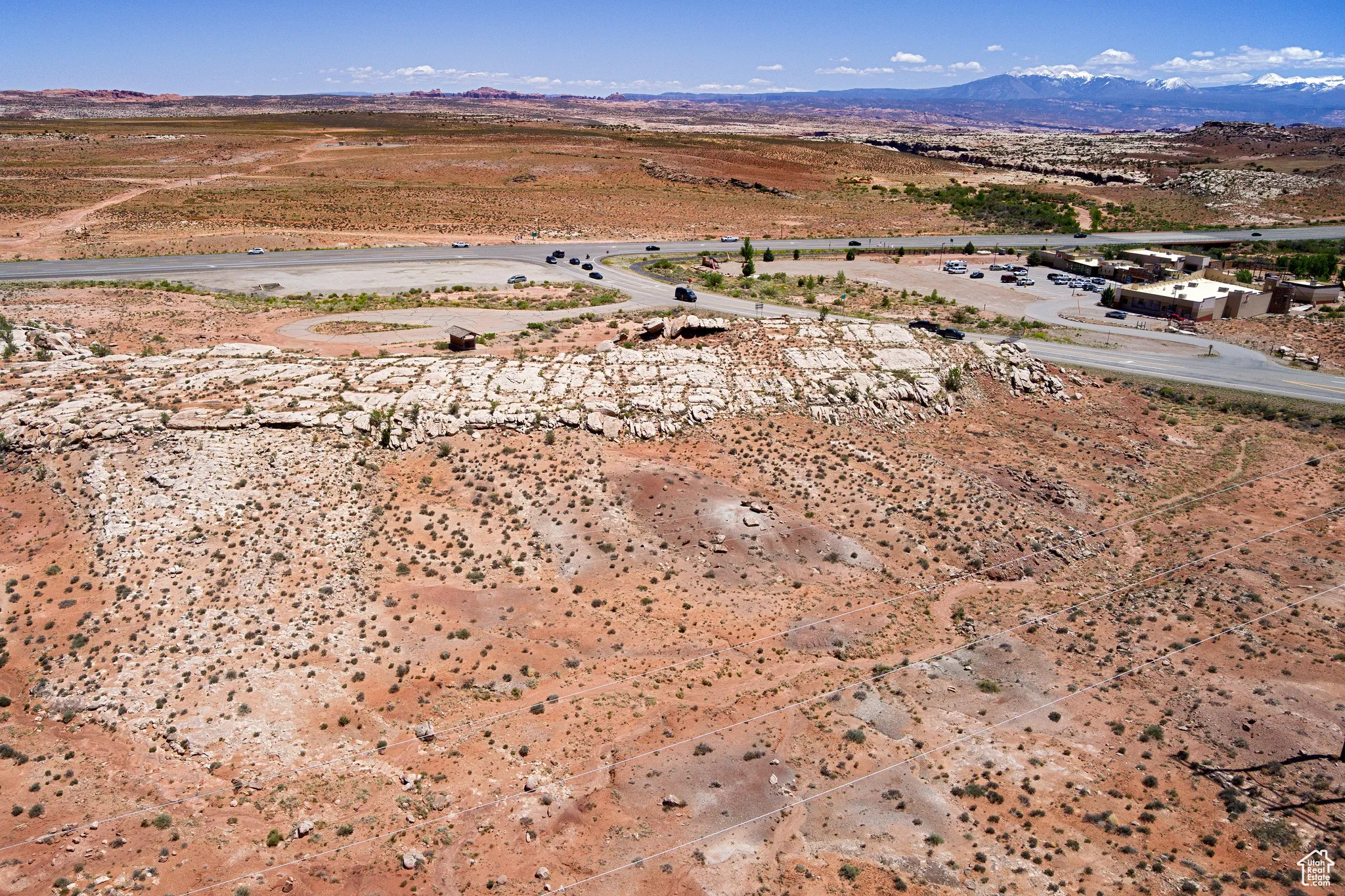 Aerial view of property's location with a mountainous background