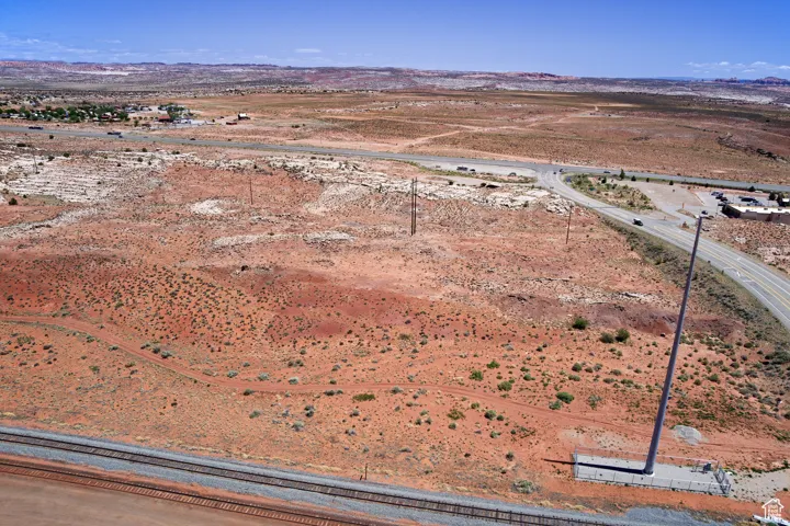 Aerial view of sparsely populated area featuring a mountainous background and a desert landscape