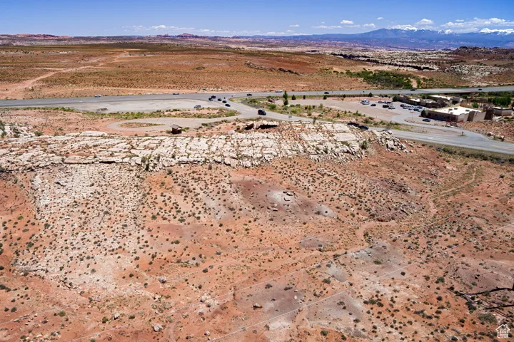 Aerial view of property's location with a mountainous background