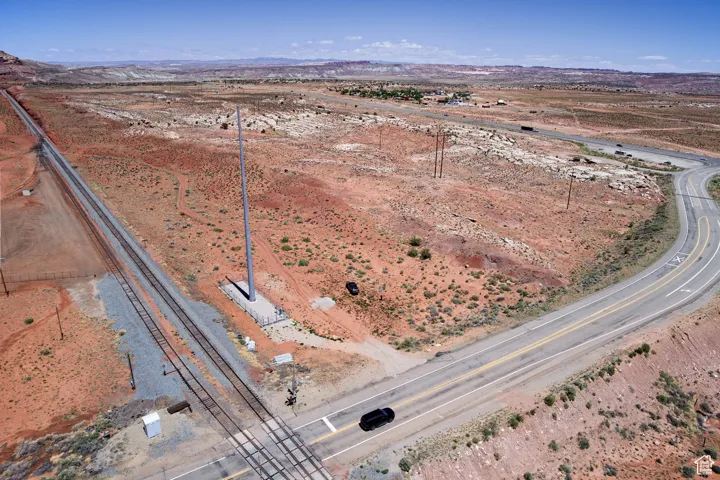 Aerial view of property and surrounding area with rural landscape, mountains, and a desert landscape