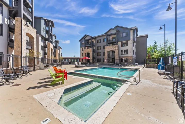 Community pool with a patio