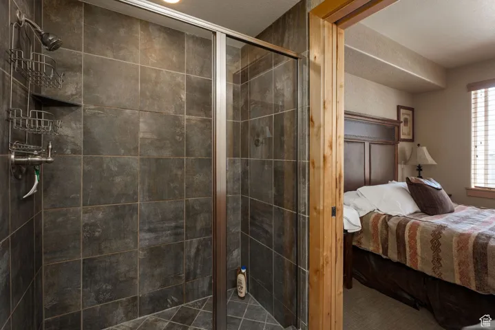 Ensuite bathroom featuring a stall shower