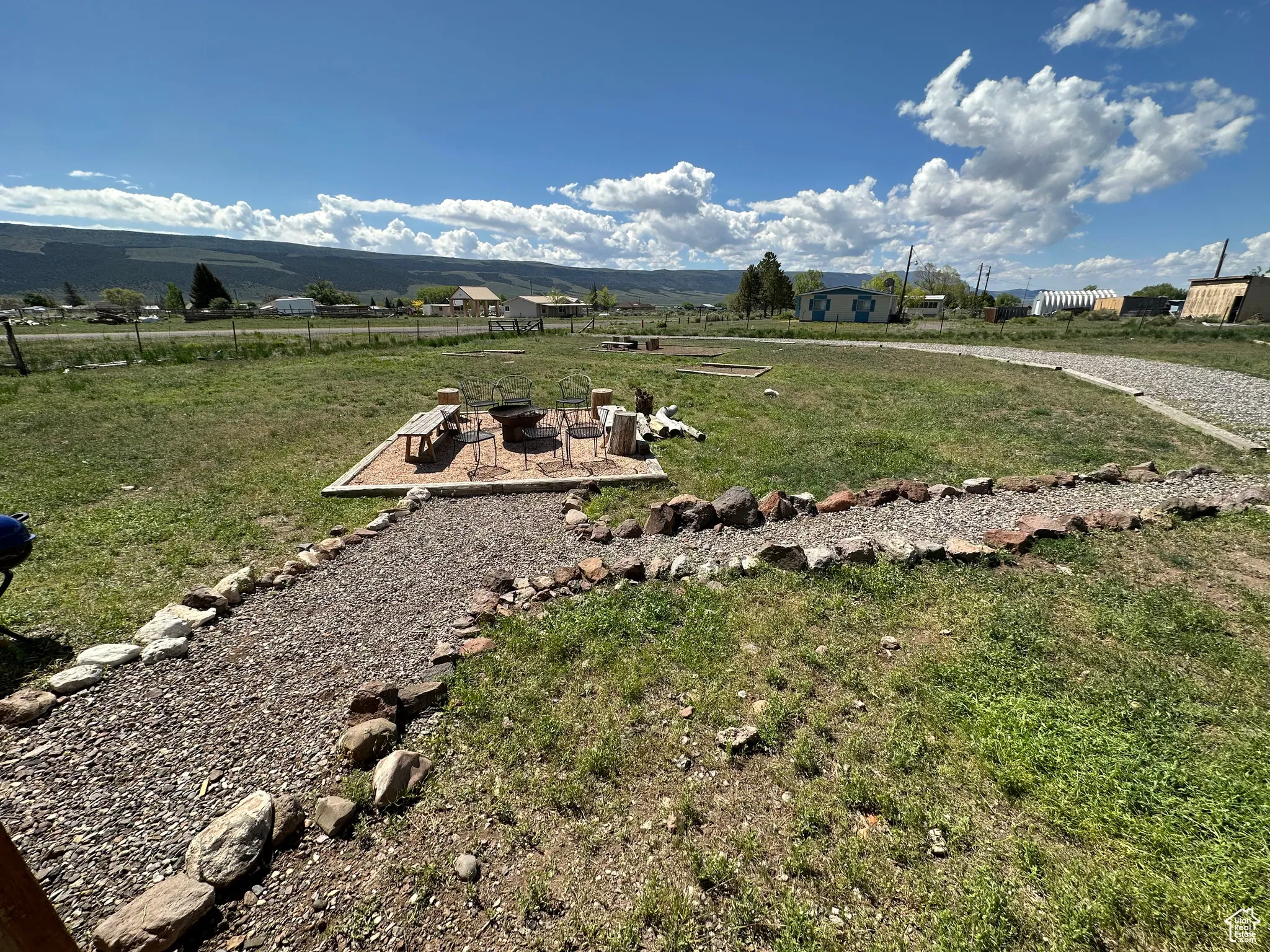 View of yard featuring a fire pit, a mountain view, and a rural view