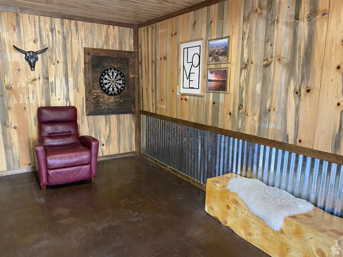 Sitting room with wood walls and finished concrete floors