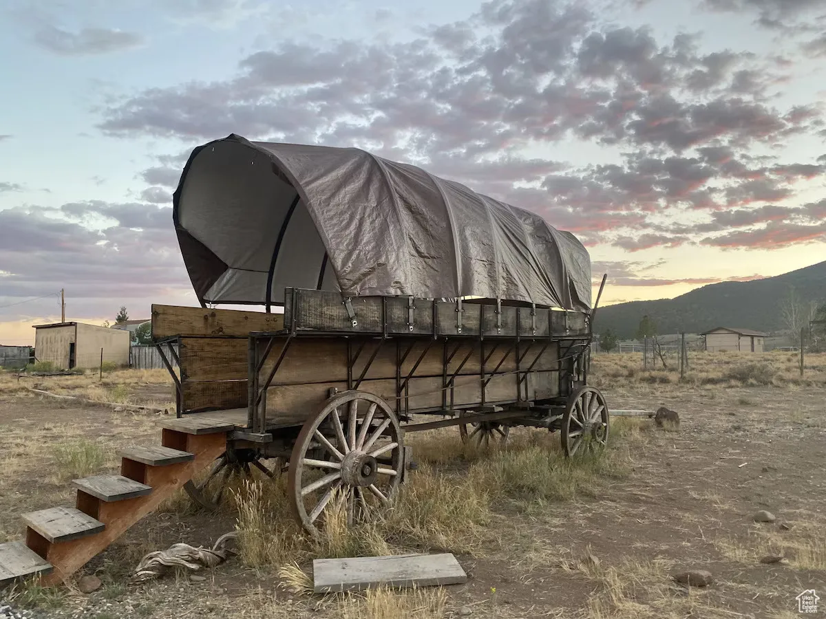 Outdoor structure at dusk featuring a barn and a mountain view
