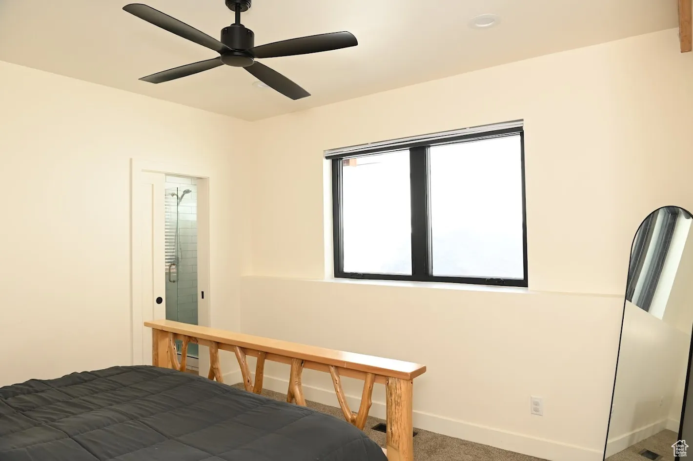 Bedroom with carpet, baseboards, and a ceiling fan