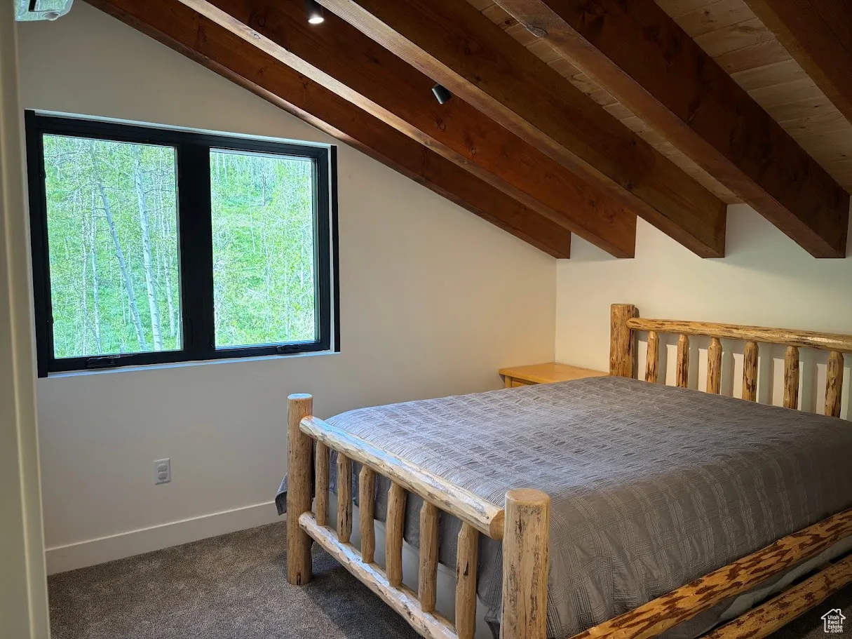 Carpeted bedroom featuring baseboards