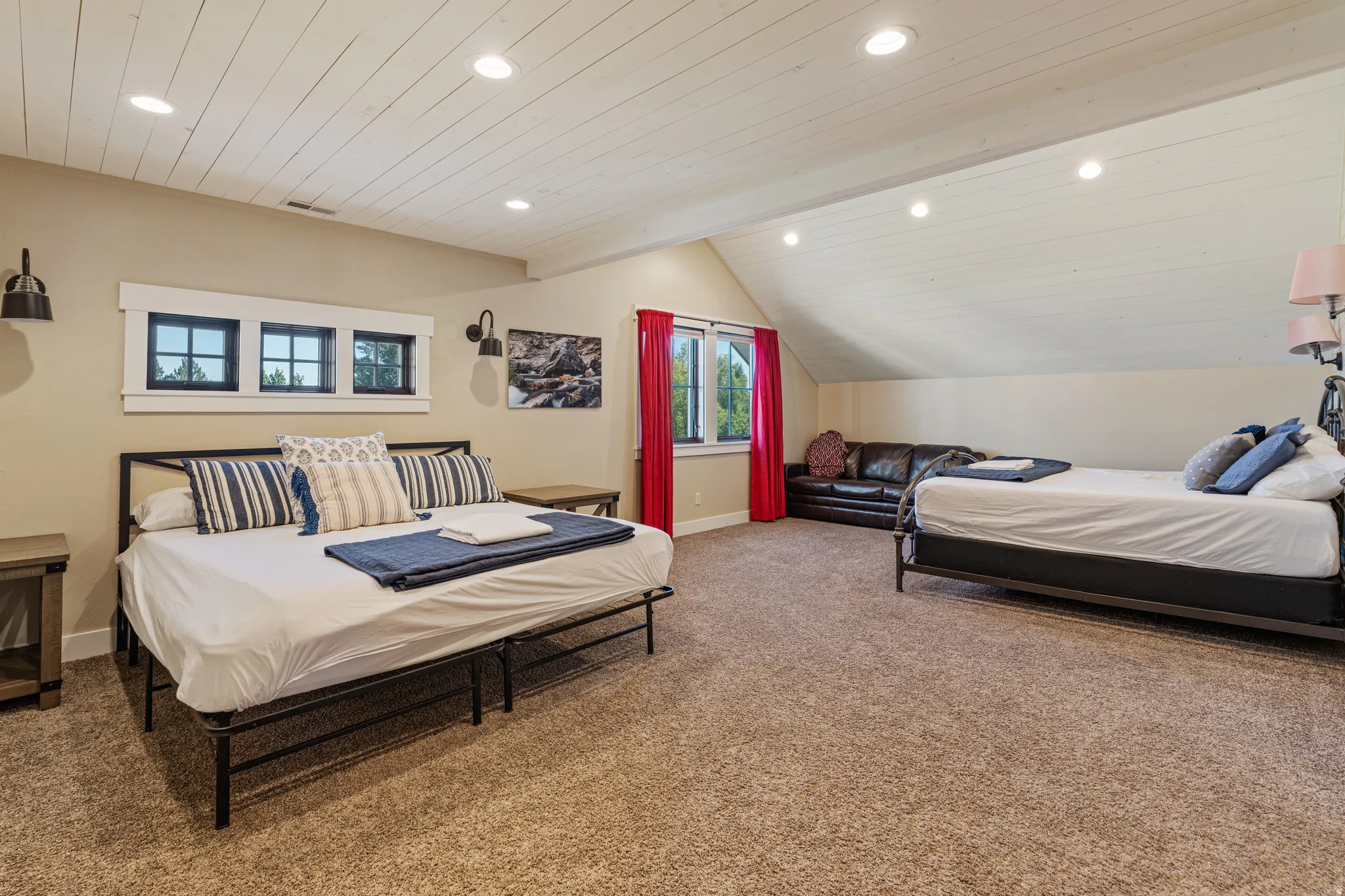 Vaulted shiplap ceiling with recessed lighting, multiple windows with black trim, and carpeted flooring