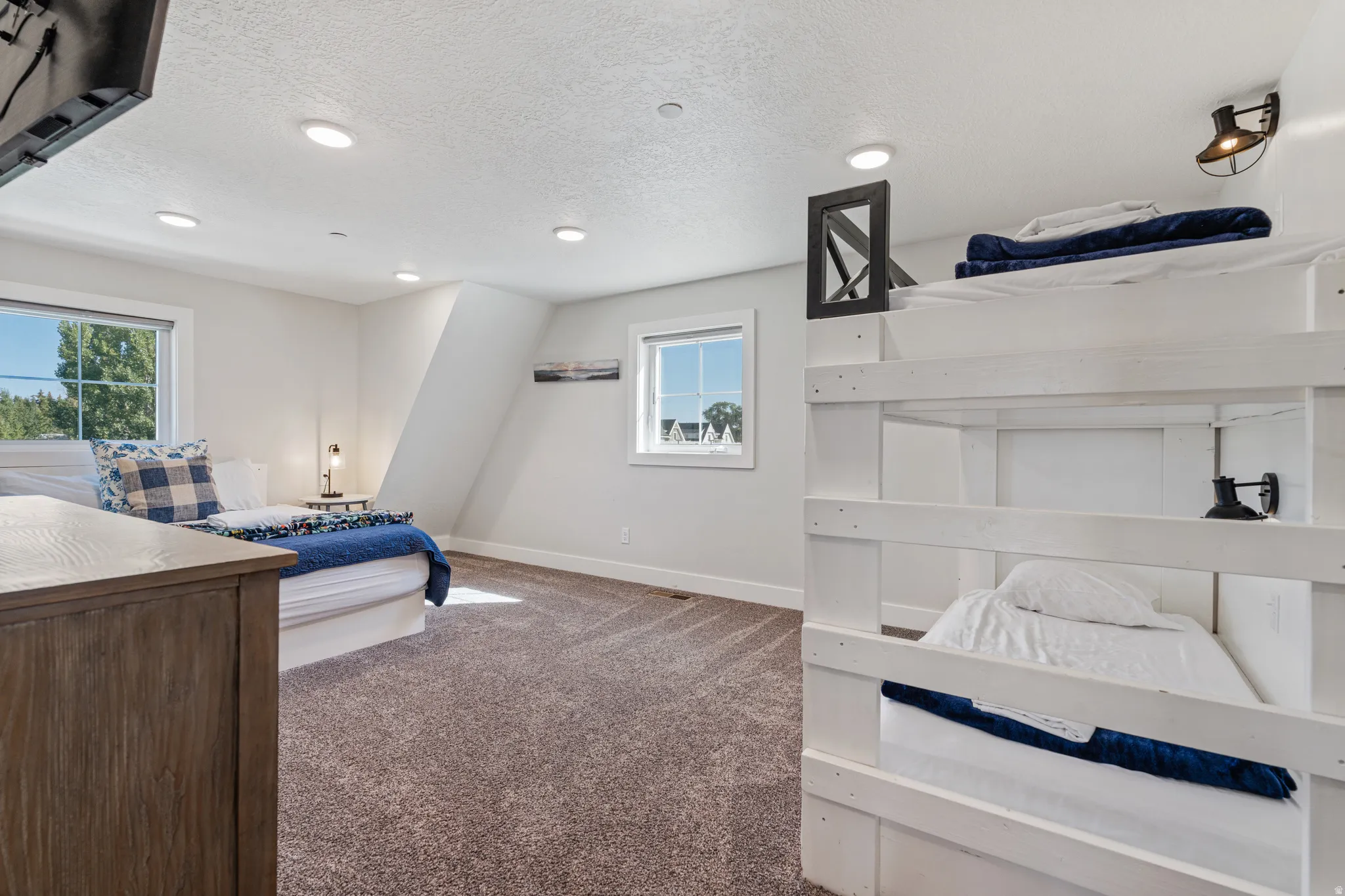 Carpeted flooring, recessed lighting, white walls, and multiple windows