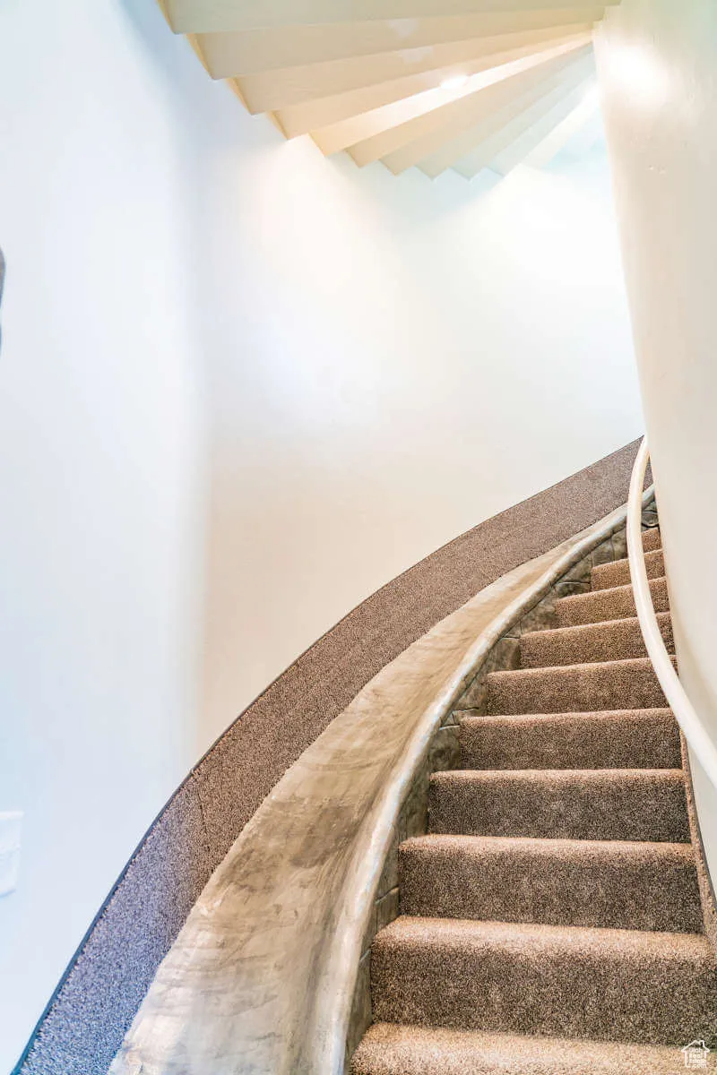 Stairway featuring beam ceiling