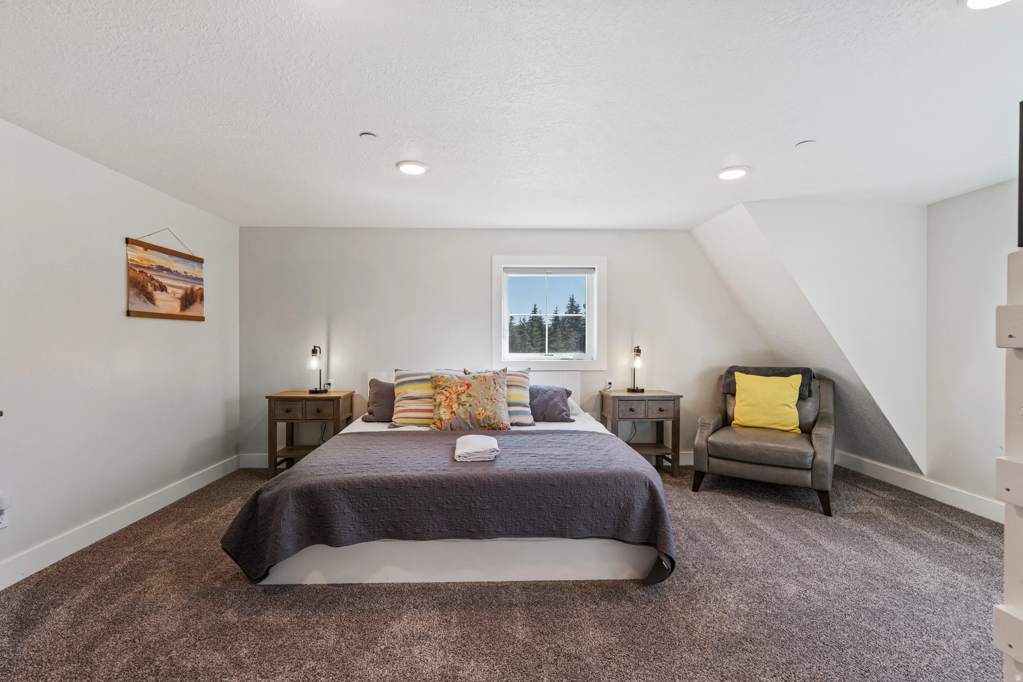 Recessed lighting, window with exterior scenery, wall-to-wall carpeting, and sloped ceiling detail