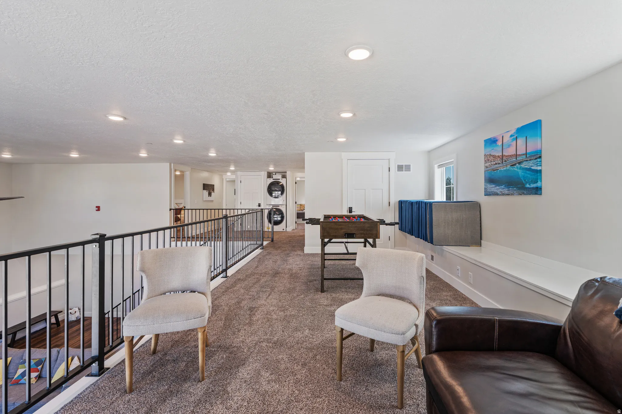 Spacious loft area featuring carpeting, recessed lighting, and a built-in window bench