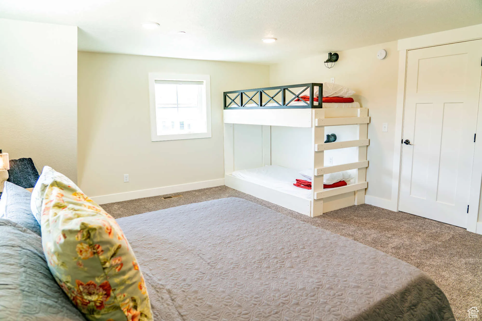 Carpeted bedroom with baseboards