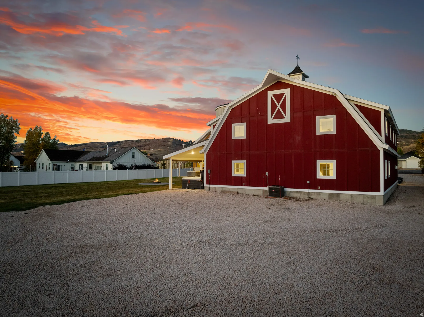 Red barn structure with white trim and multiple windows