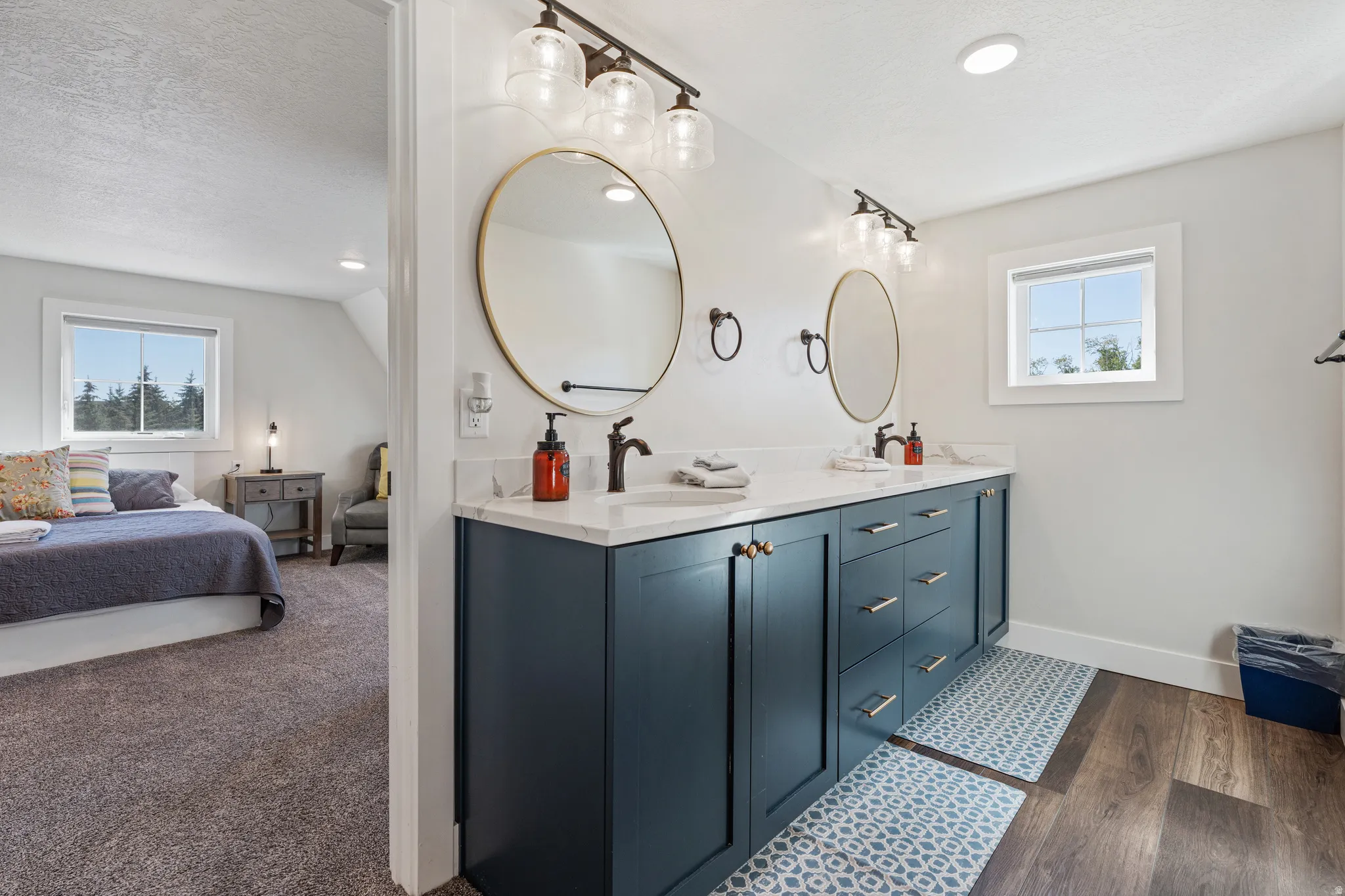 Dual vanity with white countertop, undermount sinks, and matte black fixtures