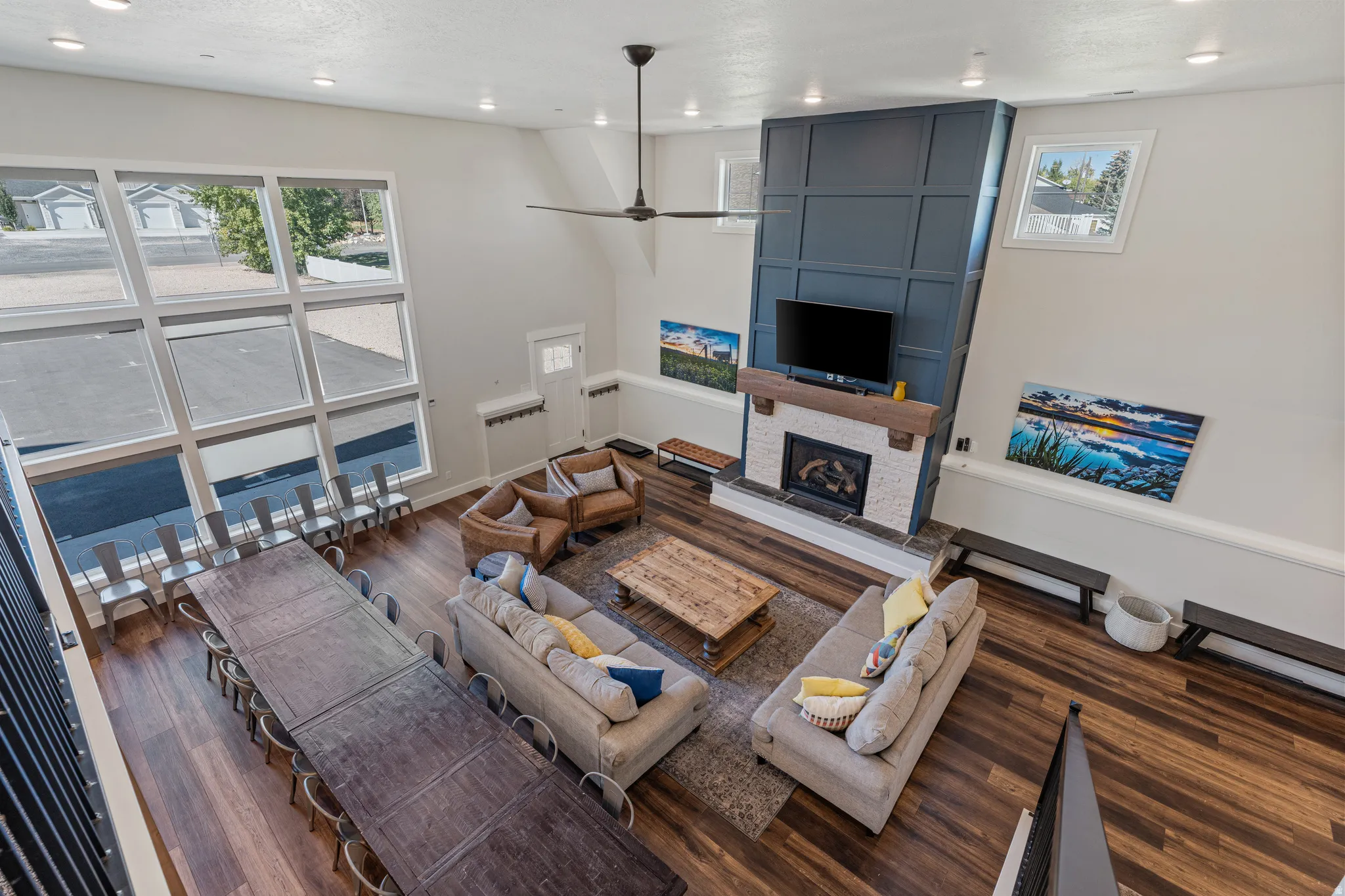 Vaulted ceilings, extensive wood-finish flooring, and a stone-surround fireplace with a wood mantel