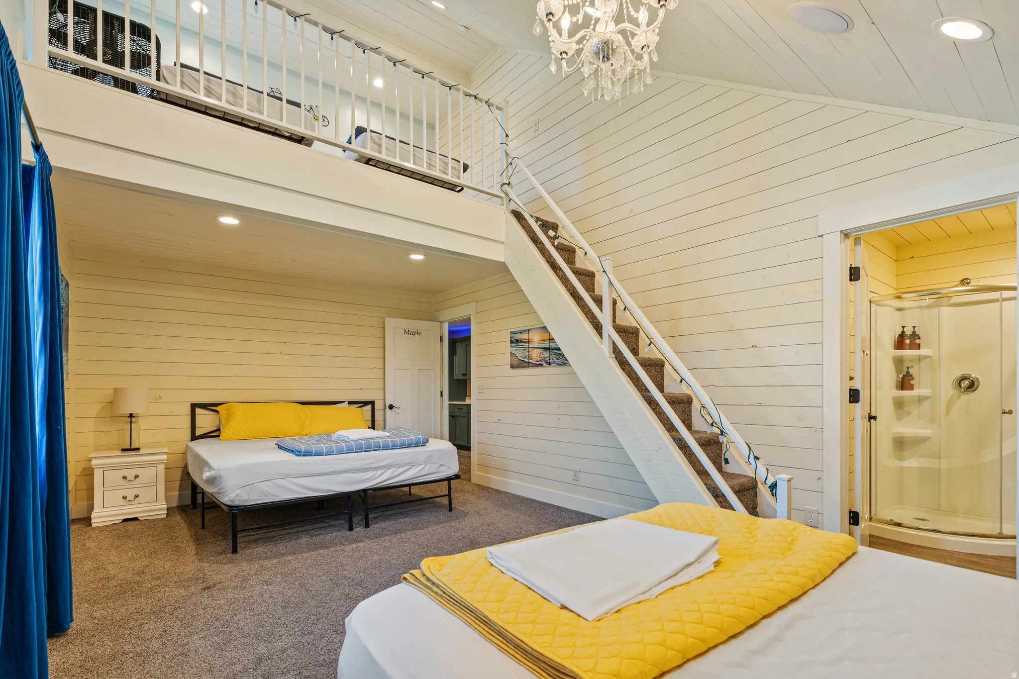 High ceilings with exposed wood planks, a loft space with white railings, a built-in staircase with carpeted treads, shiplap wall finishes, and a corner shower enclosure with a clear glass door