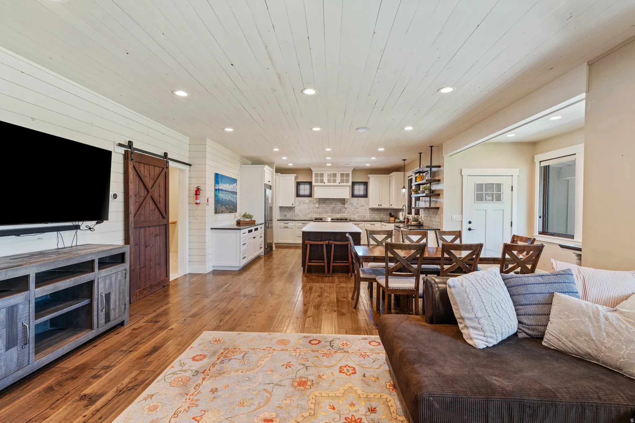 Wood-finish flooring throughout, with a shiplap accent wall and ceiling