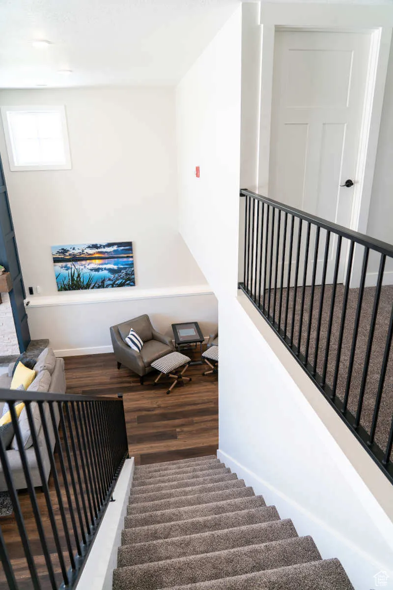 Staircase featuring wood finished floors and baseboards