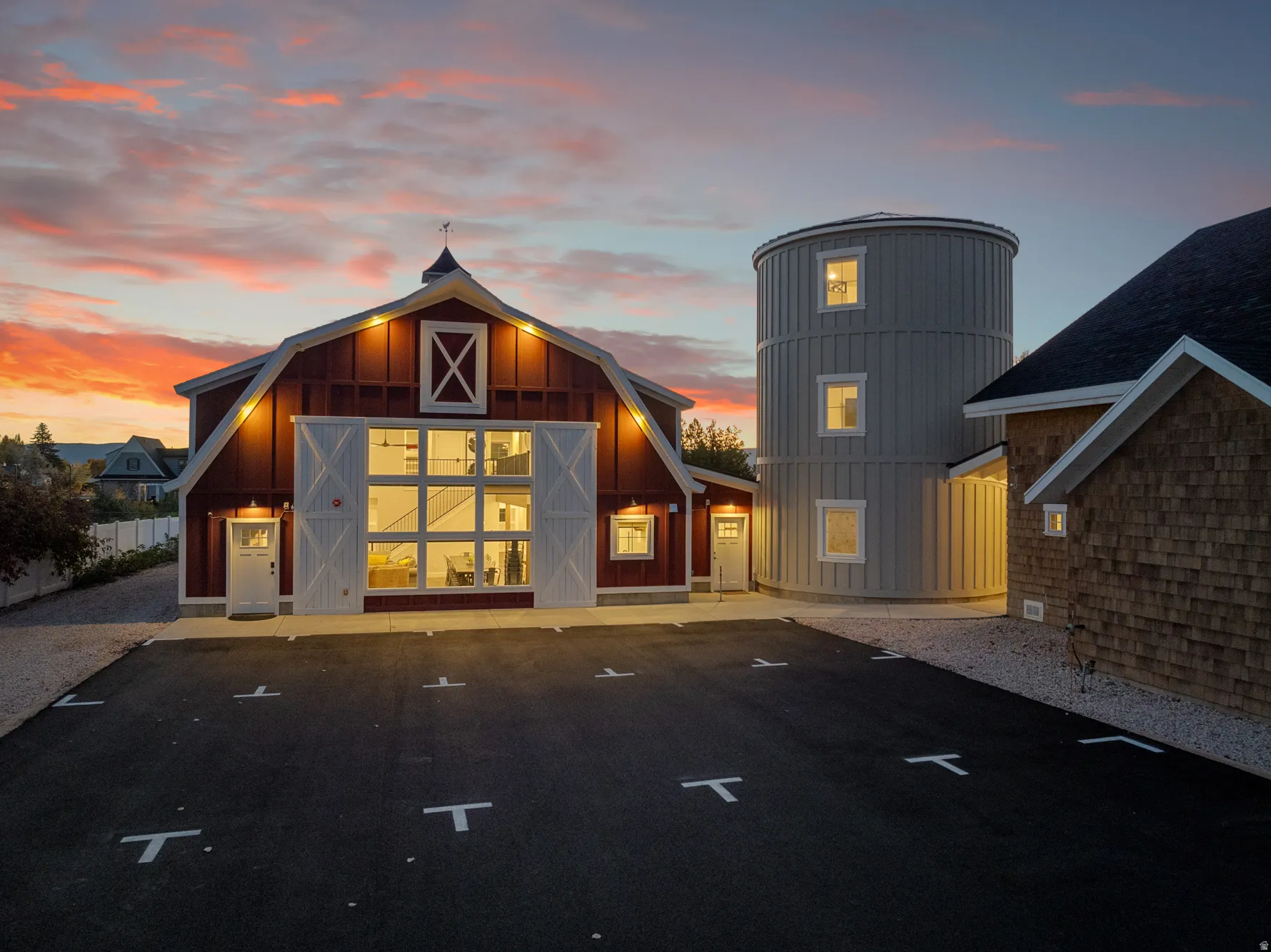 Barn-style architecture featuring a gambrel roof and cupola