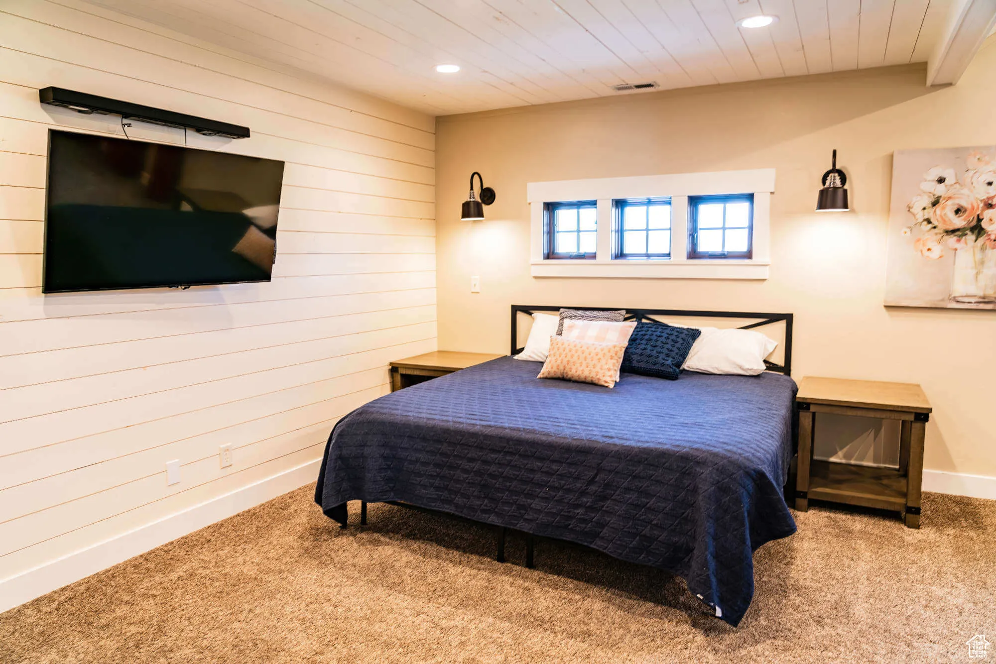 Carpeted bedroom featuring wood walls, recessed lighting, baseboards, and wood ceiling