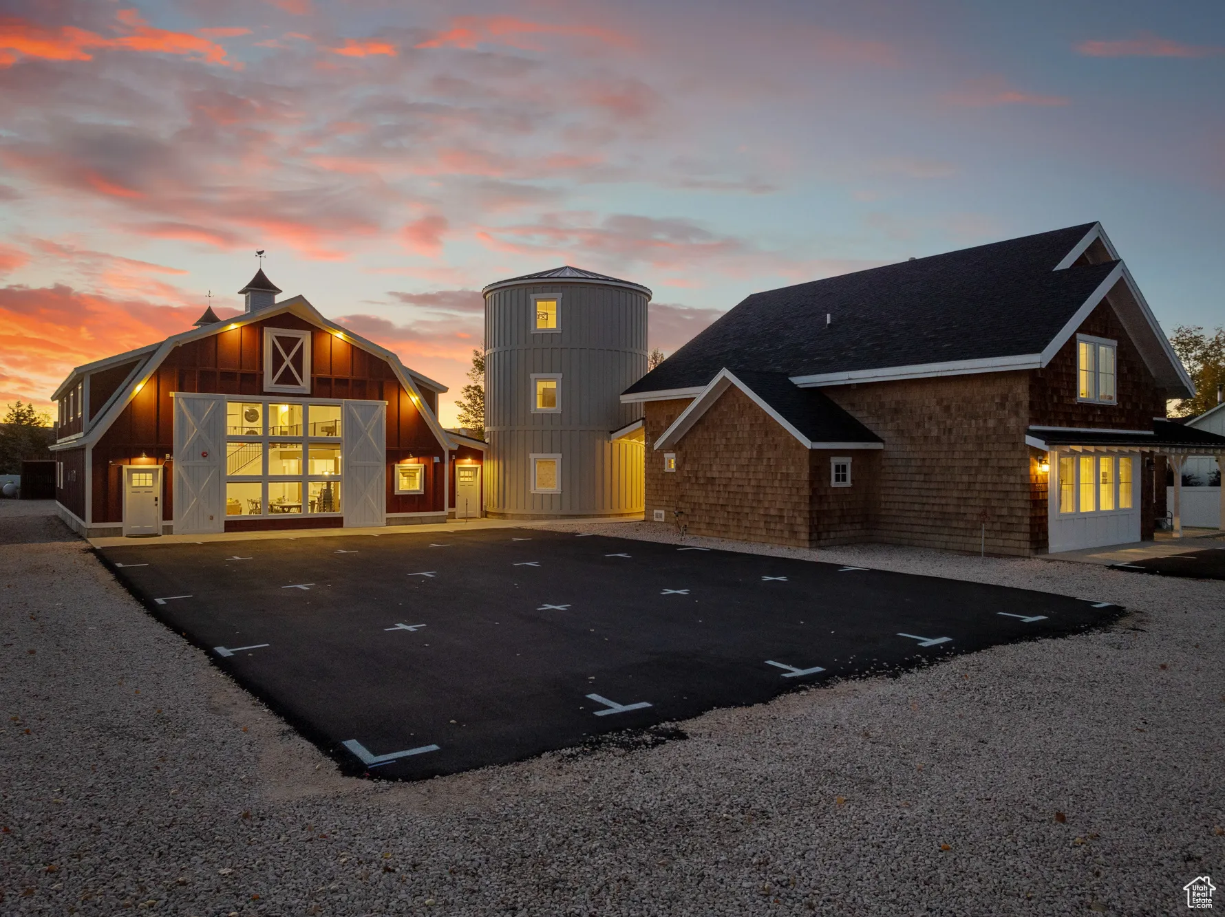 Back of property featuring a barn, uncovered parking, an outdoor structure, and a shingled roof