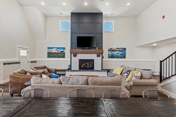 Vaulted ceilings enhance the open concept living area, featuring wood-finish flooring