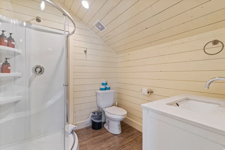Corner shower with curved glass enclosure