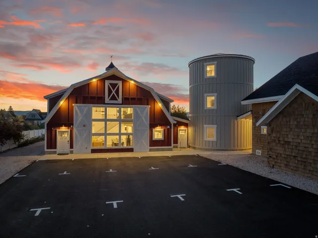 Barn-style architecture featuring a gambrel roof and cupola