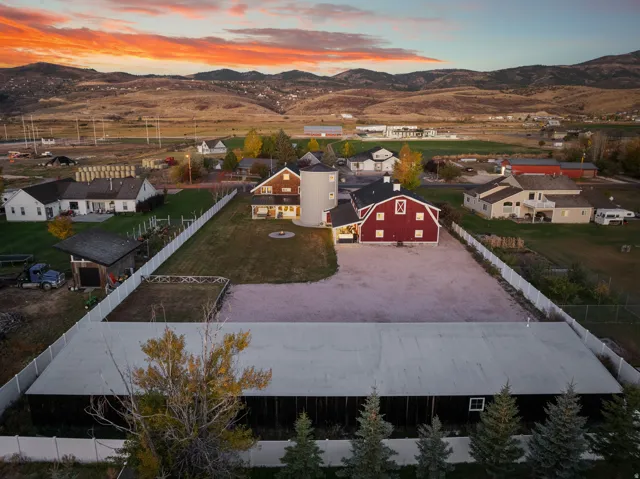 Expansive property featuring a red barn, a silo, and multiple outbuildings