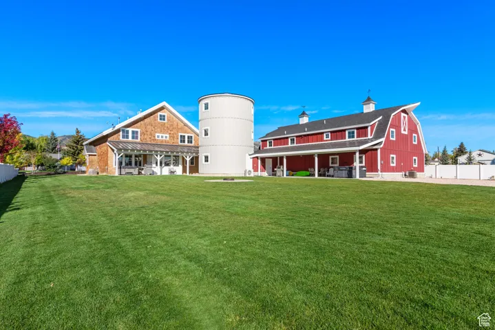 Rear view of property with a chimney and a gambrel roof